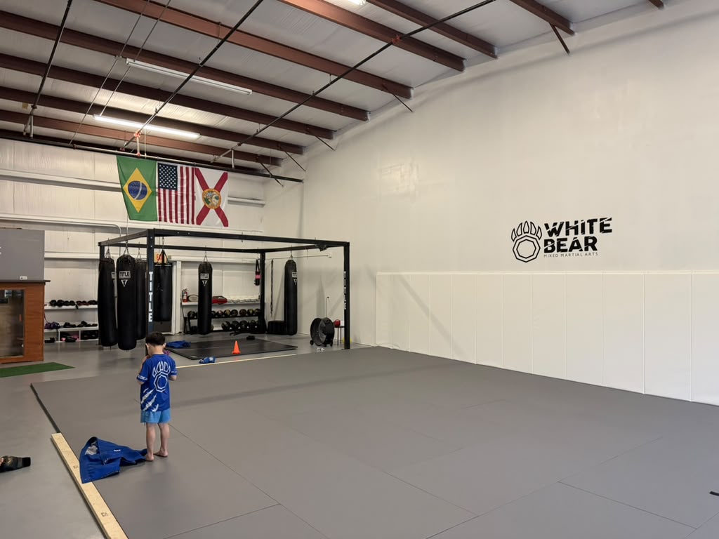 White Bear MMA training space with mats and heavy bags